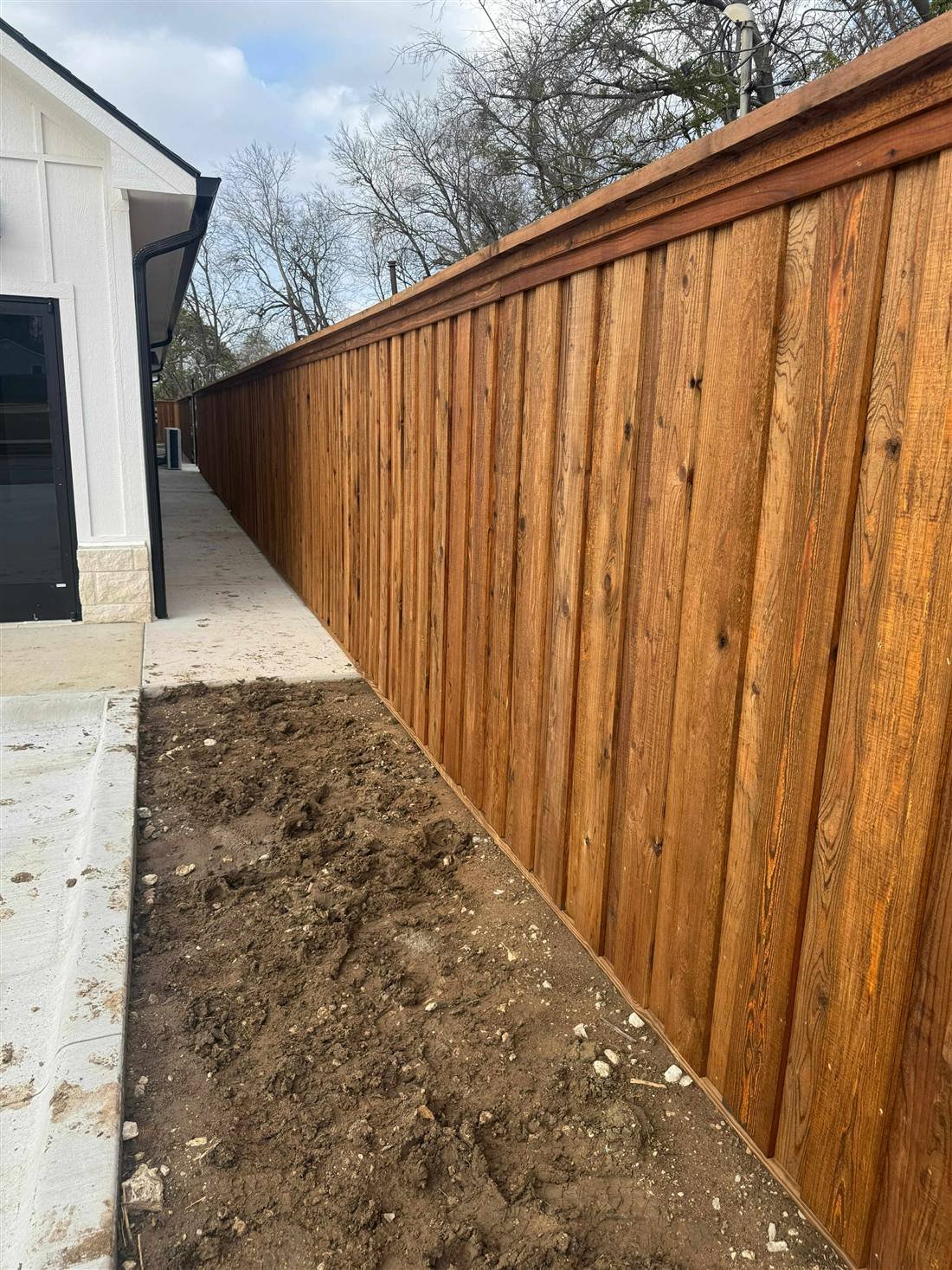 Cap-and-trim cedar fence in Prosper, TX